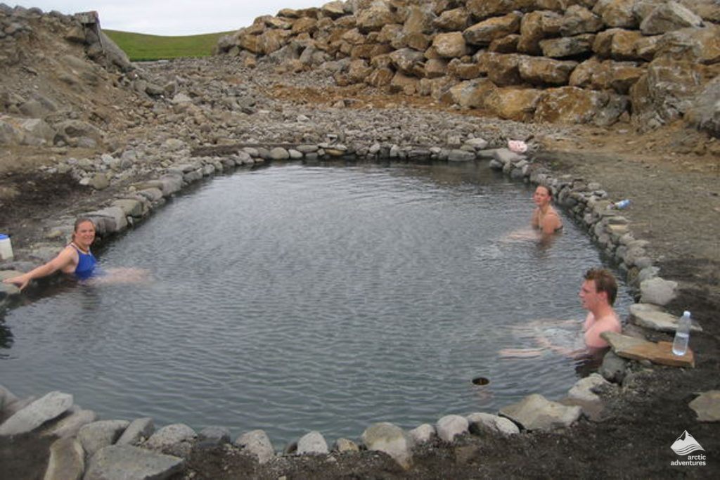 People soaking in Hveraborg hot springs