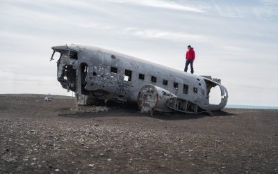 A tourist man standing on the plane wreck